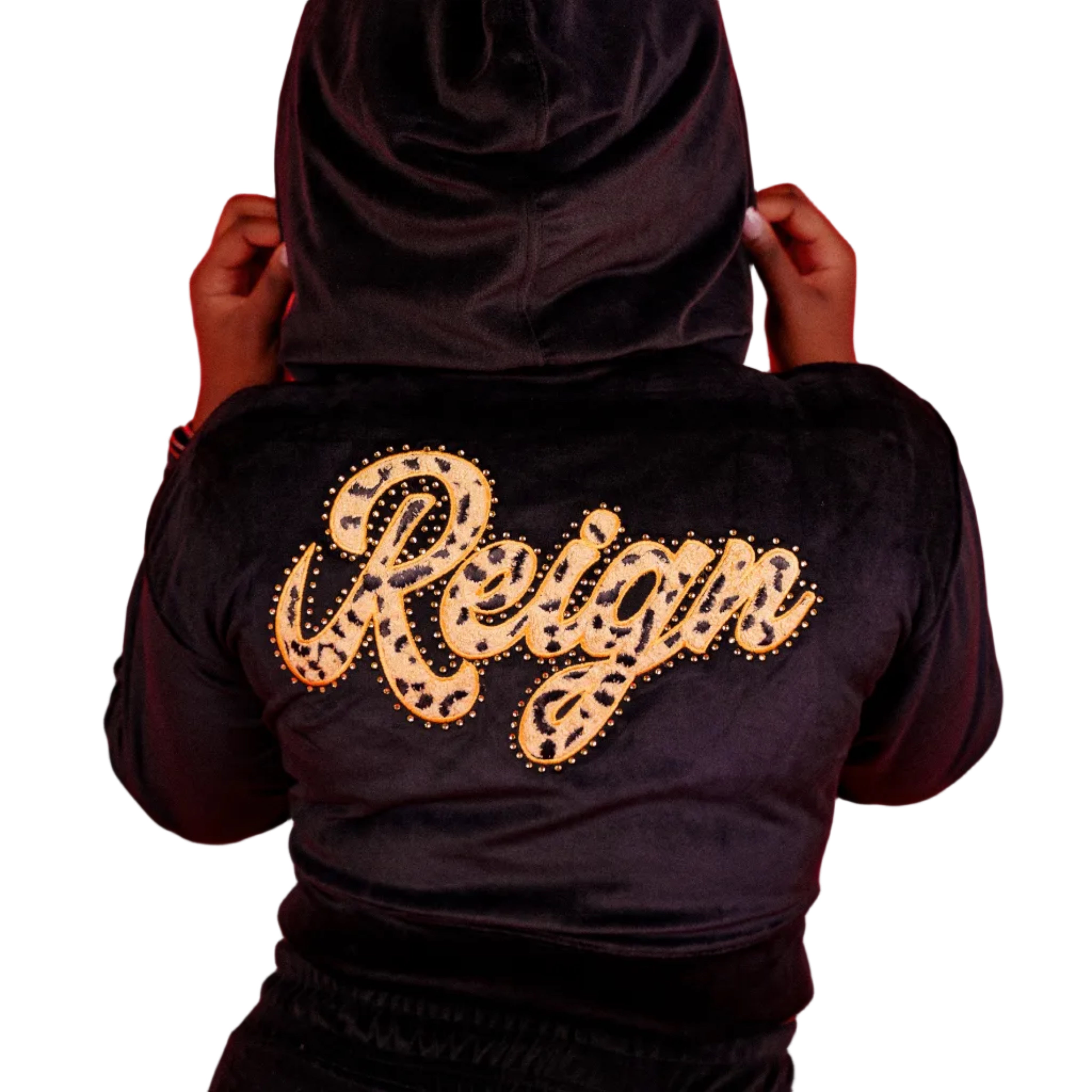 Person wearing a black hoodie with 'Reign' written in gold on a red background